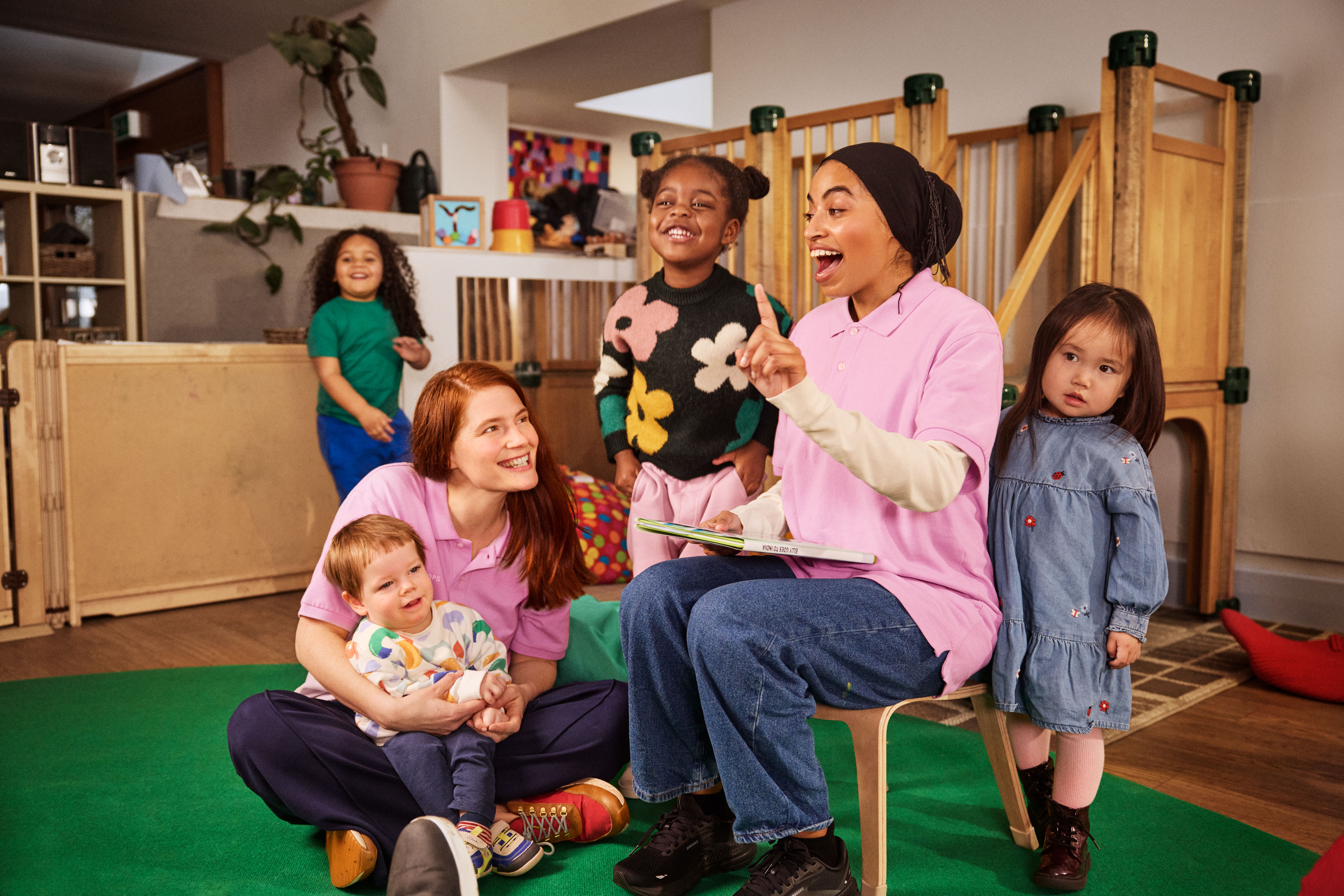 Childcare provider setting - early years workers playing with children